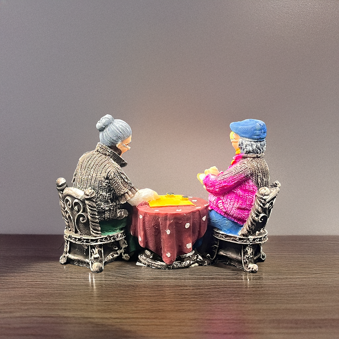 Shared Sips of Love: Elderly Couple Tea Time Sculpture