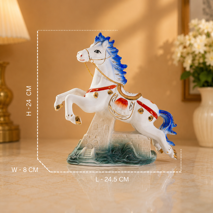 A decorative white horse figurine with blue mane and tail, red harness details, and a stone-textured base, shown on a tabletop with overlaid dimension lines and text indicating 24.5 cm length, 24 cm height, and 8 cm width.