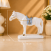 White ceramic horse figurine with a light blue saddle and gold accents, displayed on a beige tabletop with overlaid dimension lines showing height 20 cm, width 7 cm, and length 26 cm.