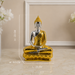 A two-tone Buddha statue with a shiny gold and silver finish, sitting on a marble surface with a blurred beige background. White dashed lines and text indicate the dimensions: H-23 CM, W-9.