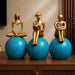 Detailed close-up of hand-painted accents, fine facial detailing, and premium Resin texture on Abstract Golden Women on Blue Spheres 3-Piece Resin Set (11 Inch)