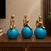 Side profile perspective showcasing elegant three-dimensional contours and sculptural depth of Abstract Golden Women on Blue Spheres 3-Piece Resin Set (11 Inch)