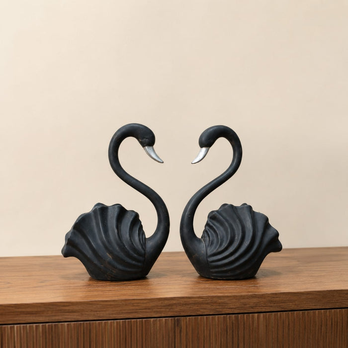 A close-up detail shot of the Black Swan Pair Figurine focusing on the artisanal carving and rich color.