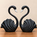 A direct front-facing view of the Black Swan Pair Figurine showcasing its vibrant details and premium finish.