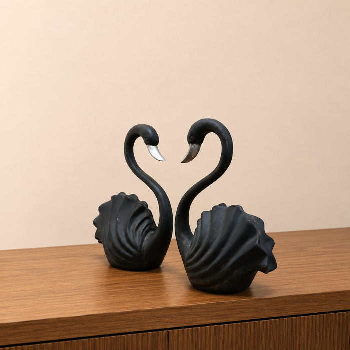 A side profile view of the Black Swan Pair Figurine revealing its graceful silhouette.