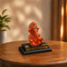 Three-quarter perspective angle view showcasing dynamic form and balanced proportions of Bright Orange Ganesha Resin Idol for Car Dashboard (4.2 Inch)