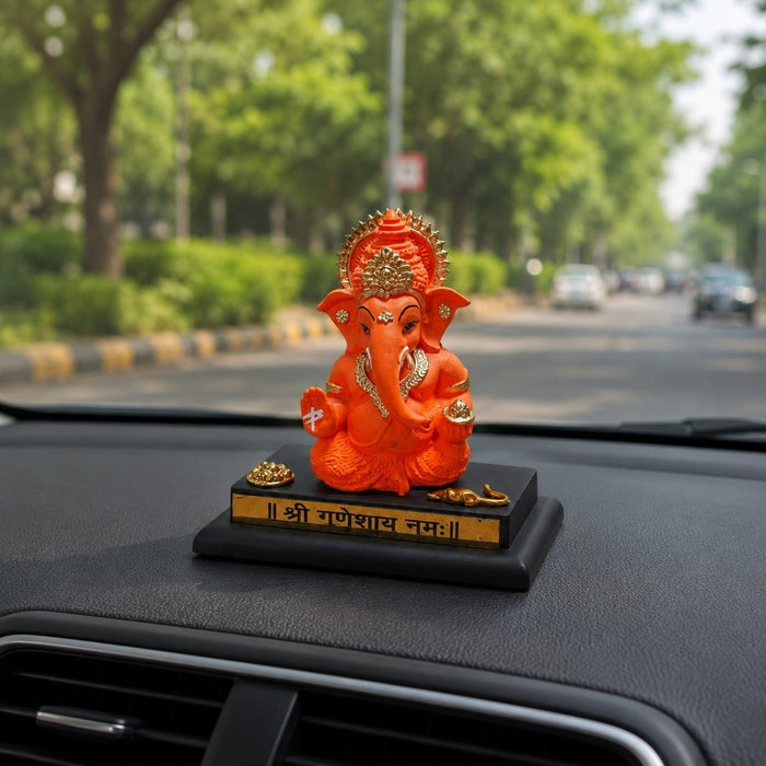 Detailed close-up of hand-painted accents, fine facial detailing, and premium Resin texture on Bright Orange Ganesha Resin Idol for Car Dashboard (4.2 Inch)