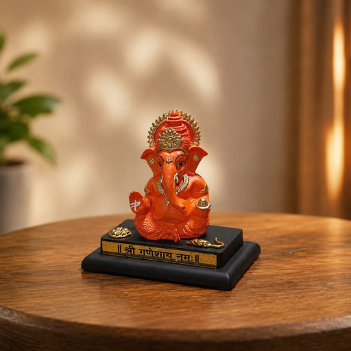 Full front view of Bright Orange Ganesha Resin Idol for Car Dashboard (4.2 Inch) on display base against clean studio background