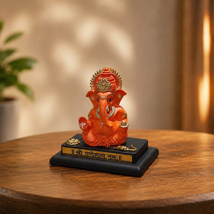 Full front view of Bright Orange Ganesha Resin Idol for Car Dashboard (4.2 Inch) on display base against clean studio background