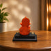 Side profile perspective showcasing elegant three-dimensional contours and sculptural depth of Bright Orange Ganesha Resin Idol for Car Dashboard (4.2 Inch)