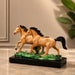Side profile perspective showcasing elegant three-dimensional contours and sculptural depth of Glossy Two Running Horses Resin Figurine on Grass Base (7.3 Inch)