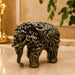 A side profile view of the Gold Antique Elephant Figurine revealing its graceful silhouette.