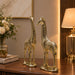 A close-up detail shot of the Gold Deer Pair Figurine focusing on the artisanal carving and rich color.