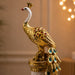 An angled perspective of the Gold Standing Peacock Figurine highlighting its elegant three-dimensional form and craftsmanship.