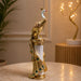 The Gold Standing Peacock Figurine beautifully styled in a modern home interior setting to inspire decor placement.