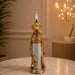 A side profile view of the Gold Standing Peacock Figurine revealing its graceful silhouette.