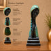 A side profile view of the Green Abstract Face Sculpture revealing its graceful silhouette.