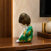 An angled perspective of the Green Little Buddha Figurine highlighting its elegant three-dimensional form and craftsmanship.