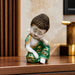 A close-up detail shot of the Green Little Buddha Figurine focusing on the artisanal carving and rich color.