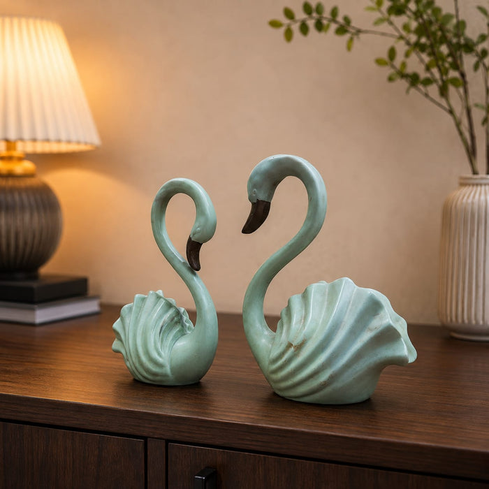 An angled perspective of the Green Swan Pair Figurine highlighting its elegant three-dimensional form and craftsmanship.