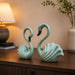 An angled perspective of the Green Swan Pair Figurine highlighting its elegant three-dimensional form and craftsmanship.