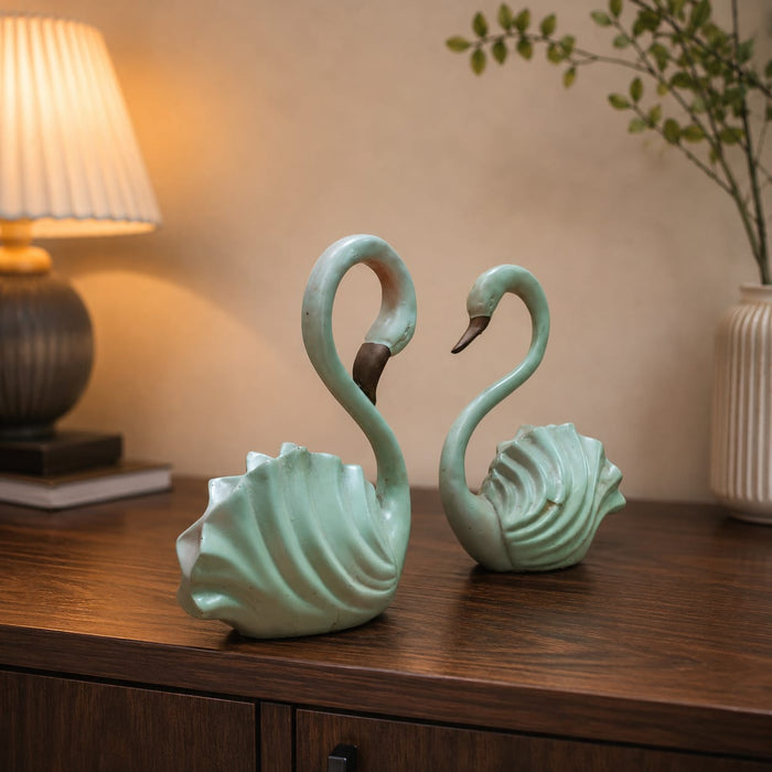 A close-up detail shot of the Green Swan Pair Figurine focusing on the artisanal carving and rich color.