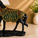 Close up of intricate traditional carvings on polyresin horse decor