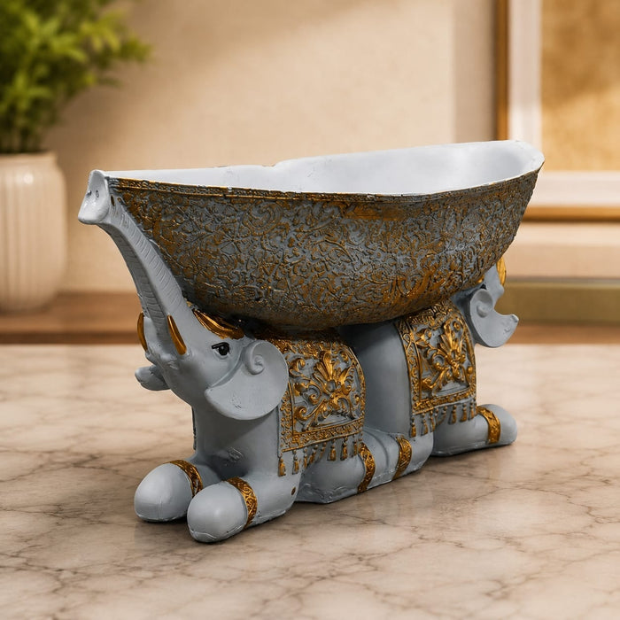 Three-quarter perspective angle view showcasing dynamic form and balanced proportions of Large Boat-Shaped Dual Elephant Resin Catchall Bowl (6.1 Inch)