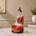 Product feature highlights and craftsmanship overview infographic for Meditating Buddha Resin Statue in Red and Gold Robe (11.5 Inch)