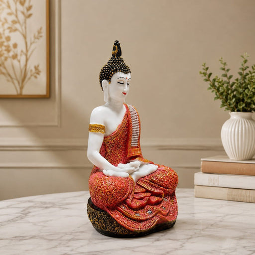 Side profile perspective showcasing elegant three-dimensional contours and sculptural depth of Meditating Buddha Resin Statue in Red and Gold Robe (11.5 Inch)