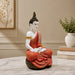 Side profile perspective showcasing elegant three-dimensional contours and sculptural depth of Meditating Buddha Resin Statue in Red and Gold Robe (11.5 Inch)
