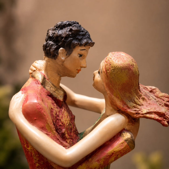 An angled perspective of the Multicolour Dancing Couple Figurine highlighting its elegant three-dimensional form and craftsmanship.