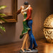 A side profile view of the Multicolour Dancing Couple Figurine revealing its graceful silhouette.