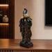A side profile view of the Multicolour Peacock Pair Figurine revealing its graceful silhouette.