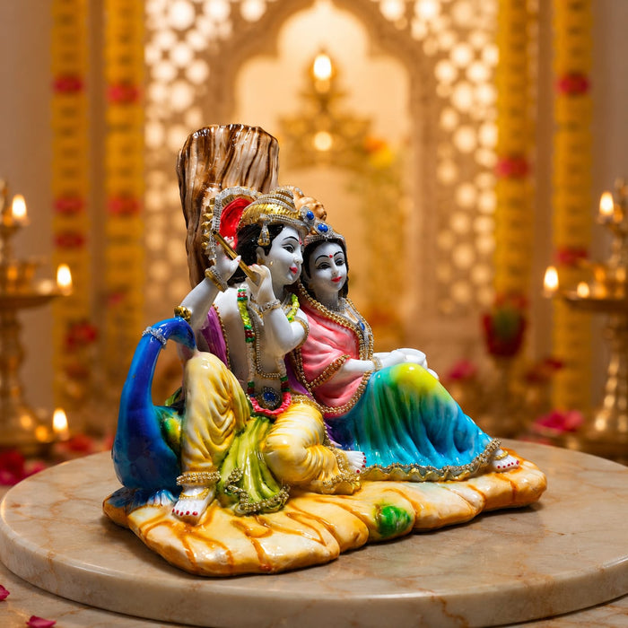 A close-up detail shot of the Multicolour Radha Krishna Idol focusing on the artisanal carving and rich color.