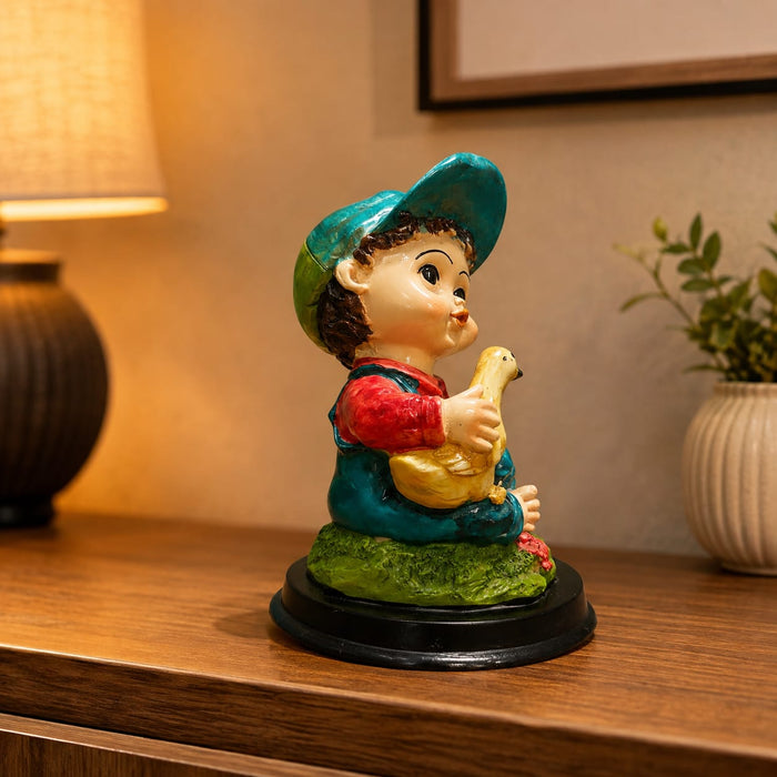 A side profile view of the Multicolour Reading Boy Figurine revealing its graceful silhouette.