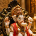 An angled perspective of the Multicolour Sitting Ganesha Idol highlighting its elegant three-dimensional form and craftsmanship.