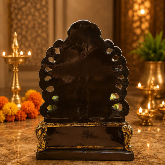 A close-up detail shot of the Multicolour Sitting Ganesha Idol focusing on the artisanal carving and rich color.