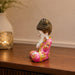 The detailed back view of the Pink Little Buddha Figurine showing the intricate texture of the material.