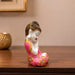 A close-up detail shot of the Pink Little Buddha Figurine focusing on the artisanal carving and rich color.