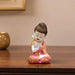 The Pink Little Buddha Figurine beautifully styled in a modern home interior setting to inspire decor placement.