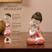 A side profile view of the Pink Little Buddha Figurine revealing its graceful silhouette.