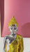 A metallic gold Buddha statue in a seated meditation pose, 