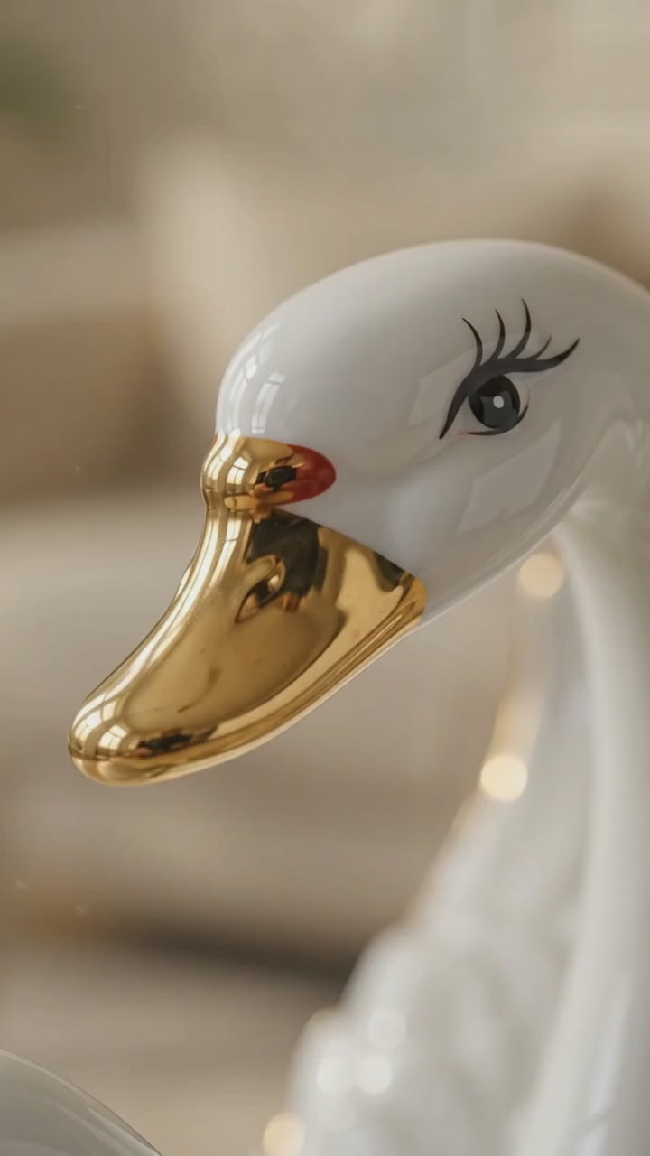 360 view of ceramic swan family showpiece
