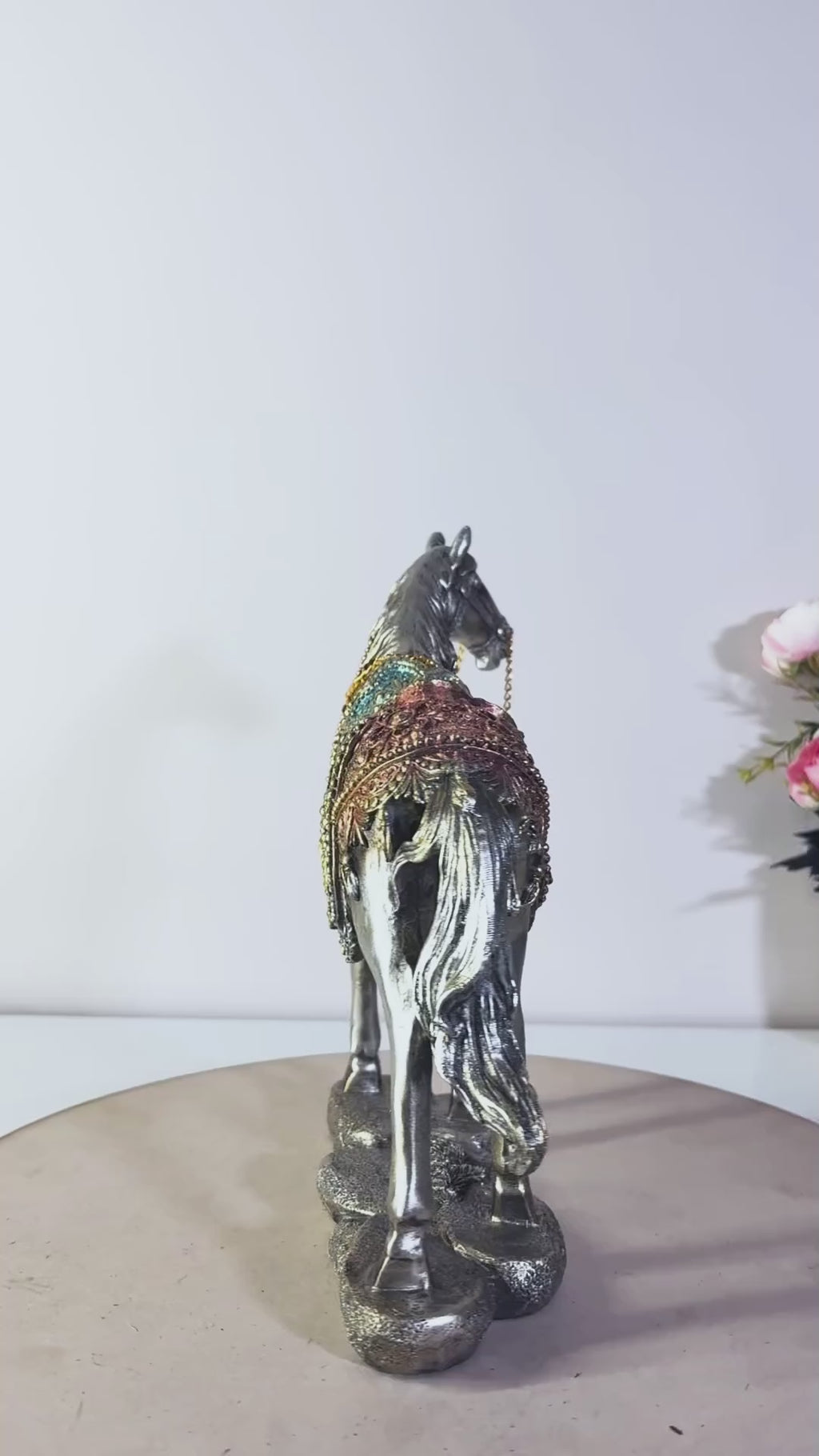 An ornate decorative horse figurine video with a silver-toned body
