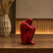 The detailed back view of the Red Abstract Yoga Figurine showing the intricate texture of the material.