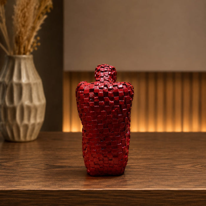 A close-up detail shot of the Red Abstract Yoga Figurine focusing on the artisanal carving and rich color.