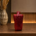 A close-up detail shot of the Red Abstract Yoga Figurine focusing on the artisanal carving and rich color.