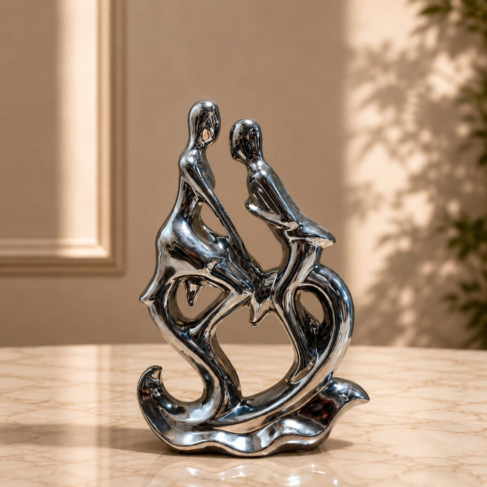 An angled perspective of the Silver Abstract Couple Figurine highlighting its elegant three-dimensional form and craftsmanship.