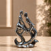 An angled perspective of the Silver Abstract Couple Figurine highlighting its elegant three-dimensional form and craftsmanship.